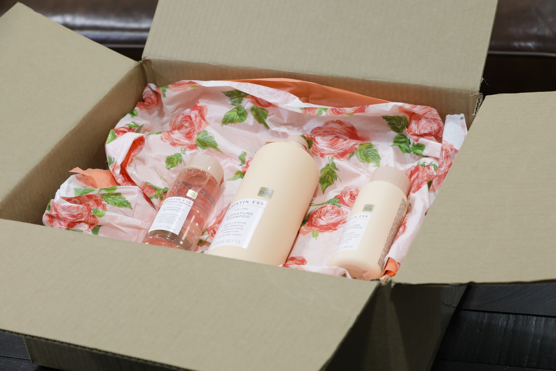 lotions and shampoos in corrugated box cushioned by custom floral pregis inspyre paper void fill