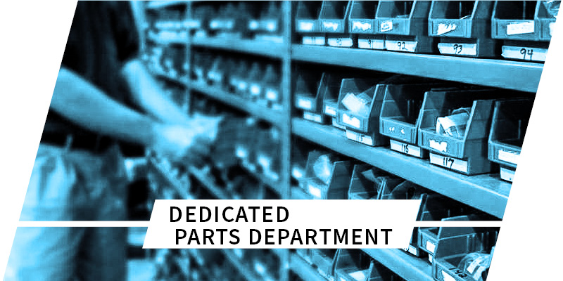 person searching through part containers on shelves with text dedicated parts department